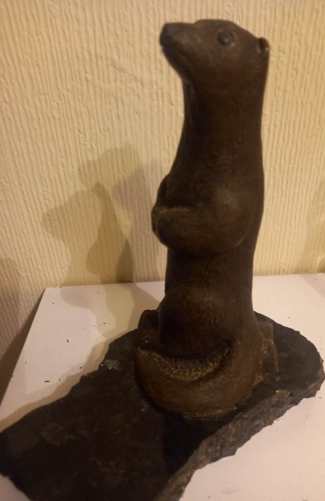 Otter figurine on natural stone