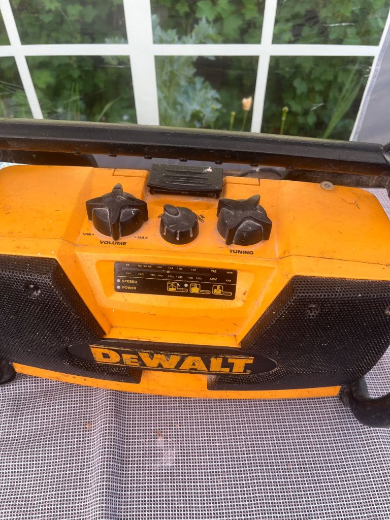 DeWalt portable radio with volume and tuning controls in good condition.