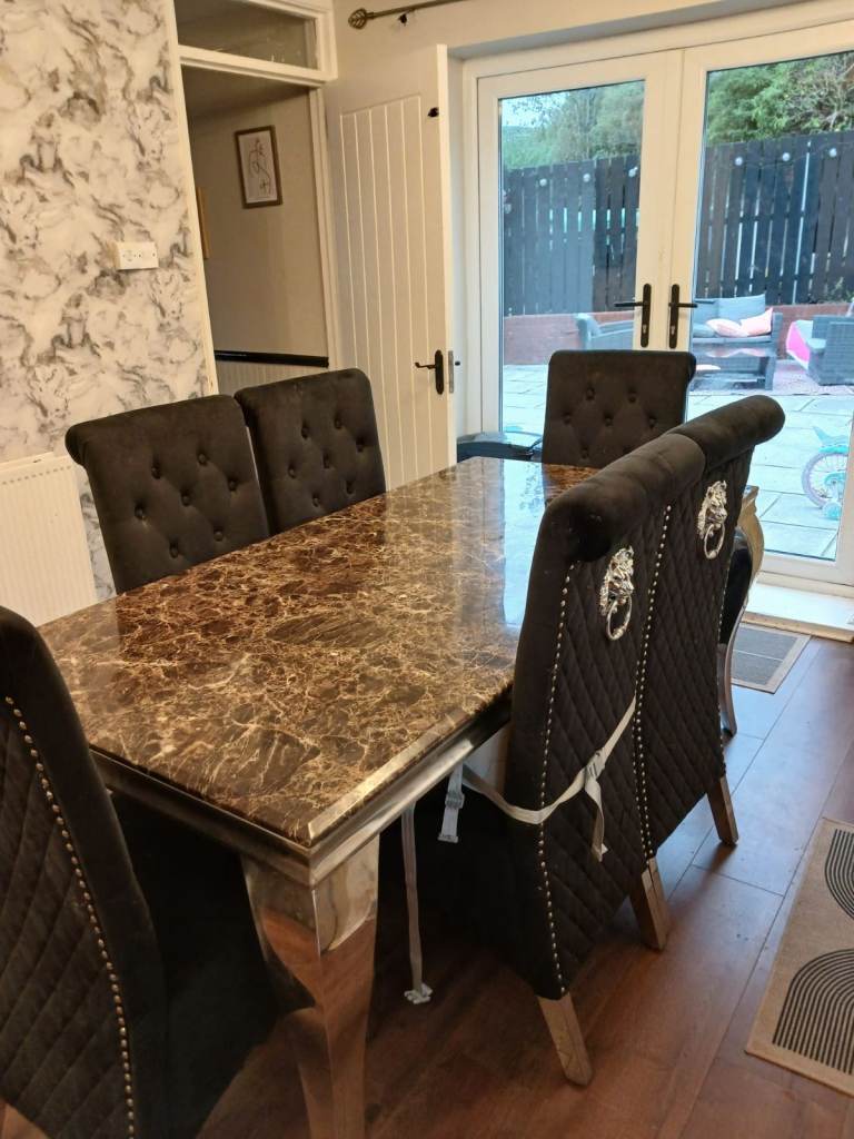 Black marble dining room table and 6 velvet lion knocker back dining room chairs    £475   