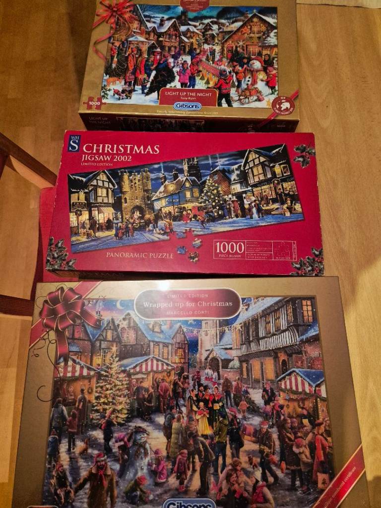 New sealed 1000 piece Gibsons Christmas jigsaw puzzle and two other opened Christmas puzzles
