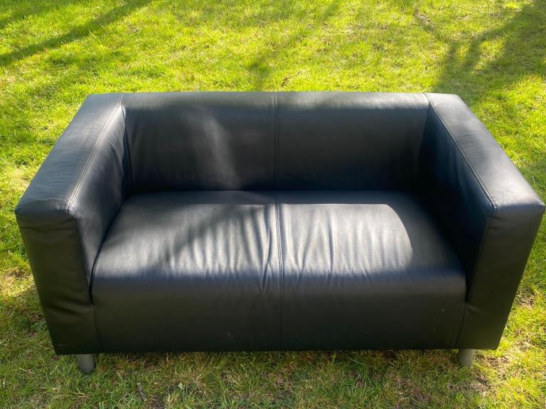 2 black leather effect sofas from Ikea , 1 matching coffee table 