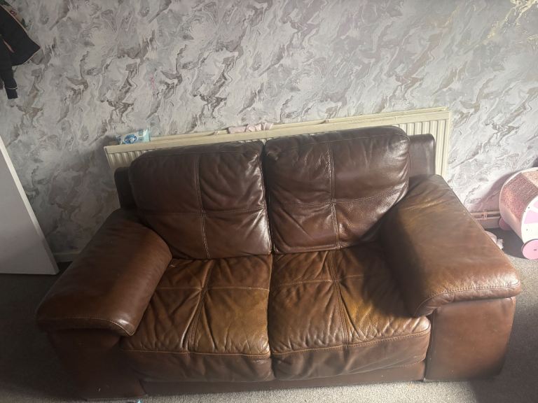 two Brown leather sofas 