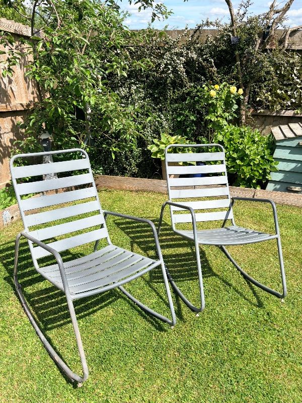 Two grey garden rocking chairs. 