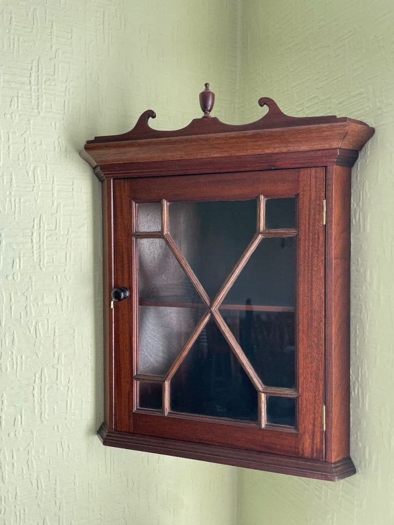 Small vintage wooden corner unit with glass door and single shelf 