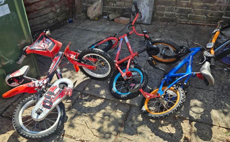 A bundle of kids' bikes and scooters