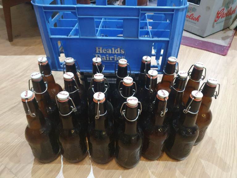 20 authentic brown vintage Grolsch bottles in handy milk crate for storage 