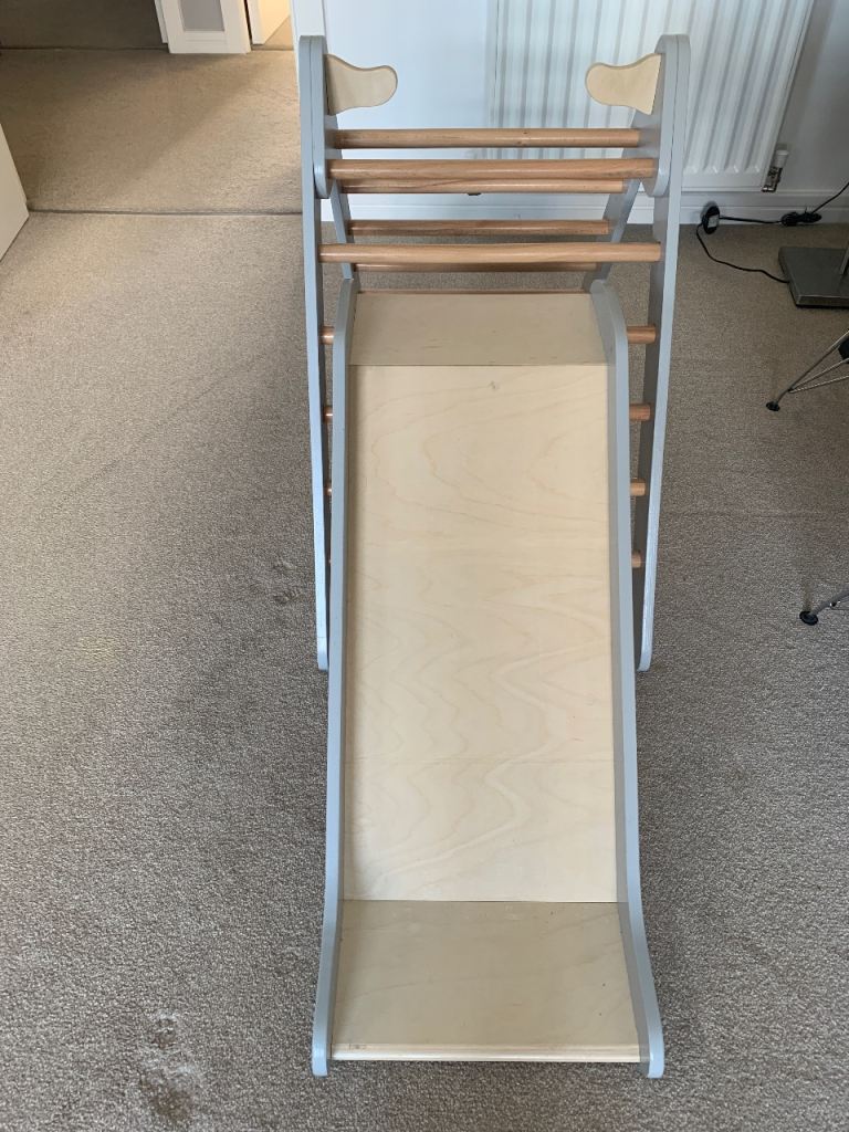 Wooden climbing frame and slide