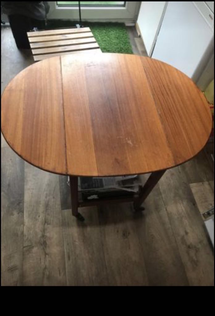 Vintage solid wood folding table on four wheels