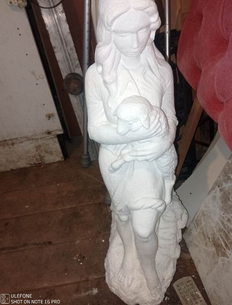 Garden statue of Little girl holding lamb