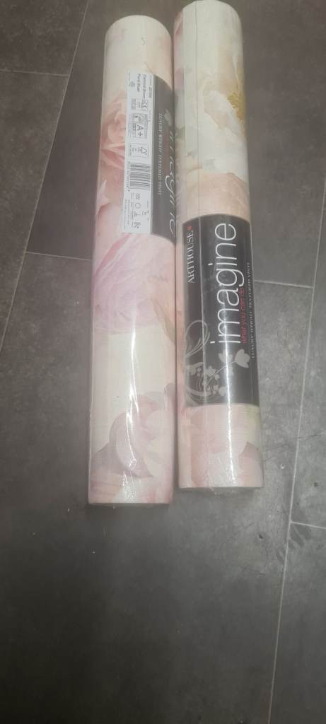 Rolls of wallpaper in various styles and designs