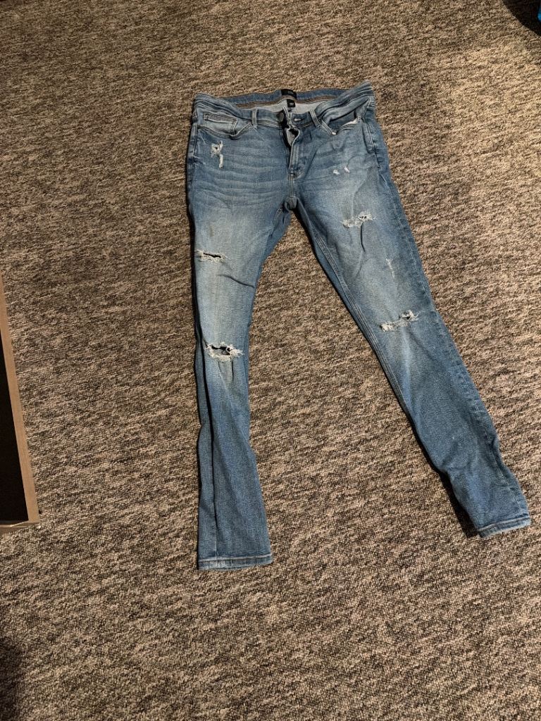 Stylish Ripped Blue Denim Jeans - Good Condition