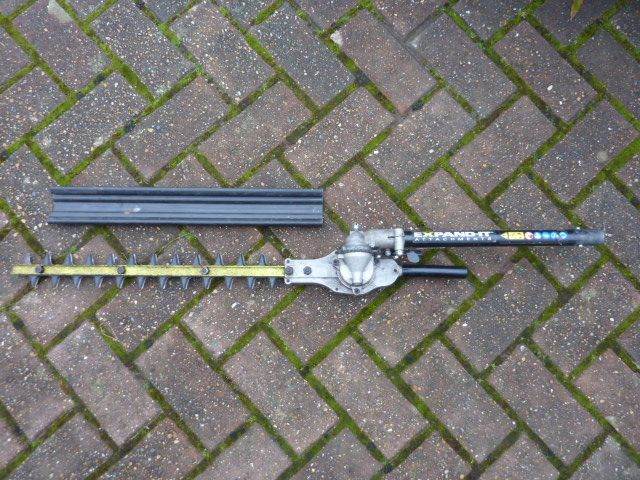 Ryobi Expand-it hedge trimmer attachment.