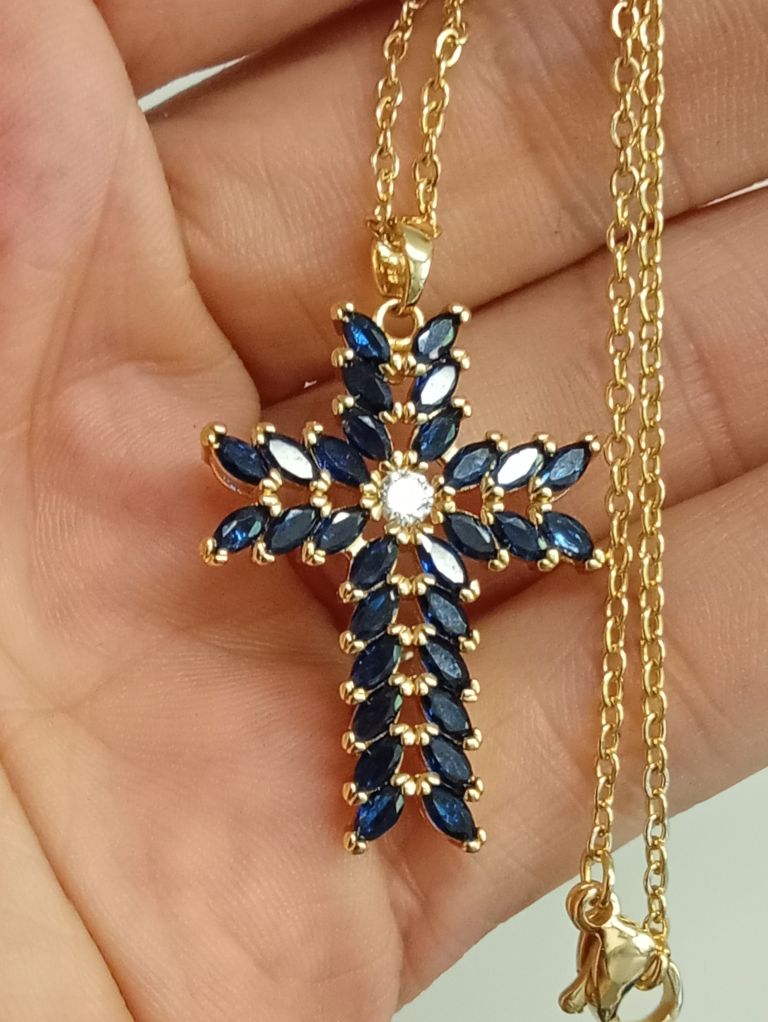 Natural sapphire and cz ornate cross 18 K gold on silver . Heavily layered.  Passed metal test 