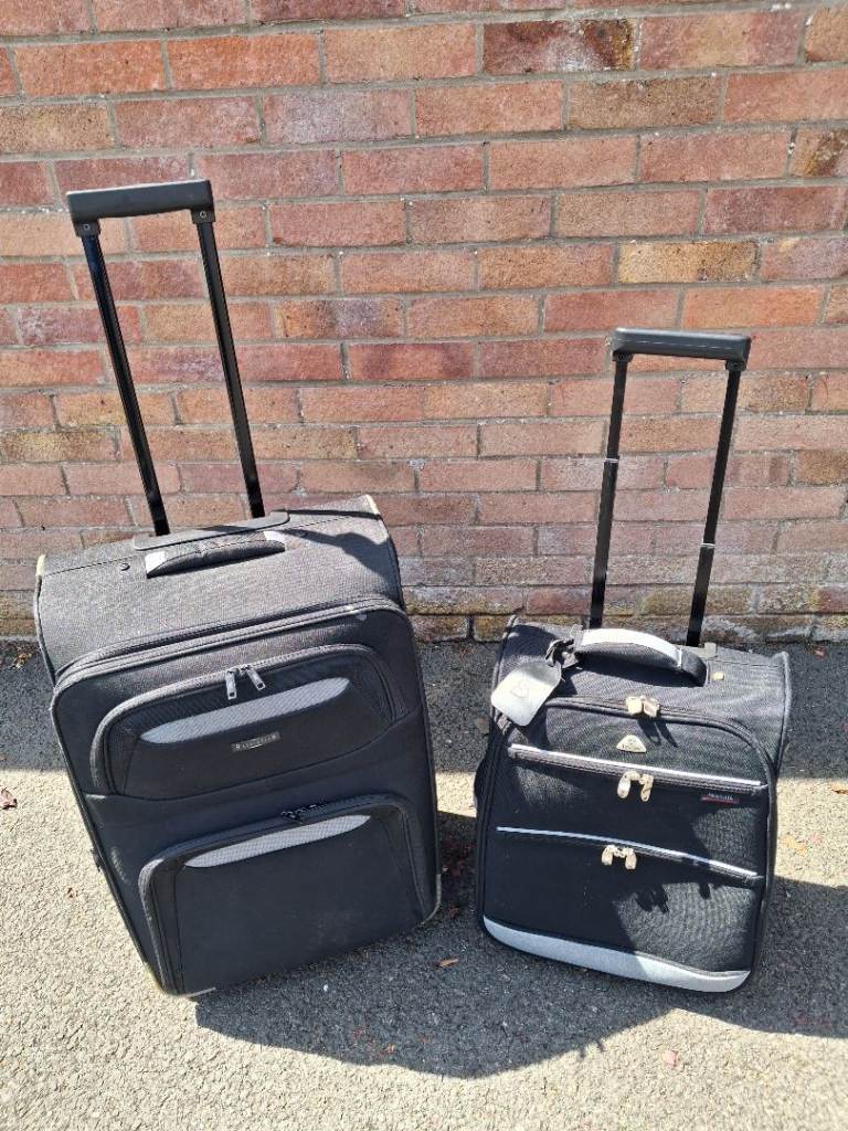 Two Black Suitcases with Wheels – Good Condition