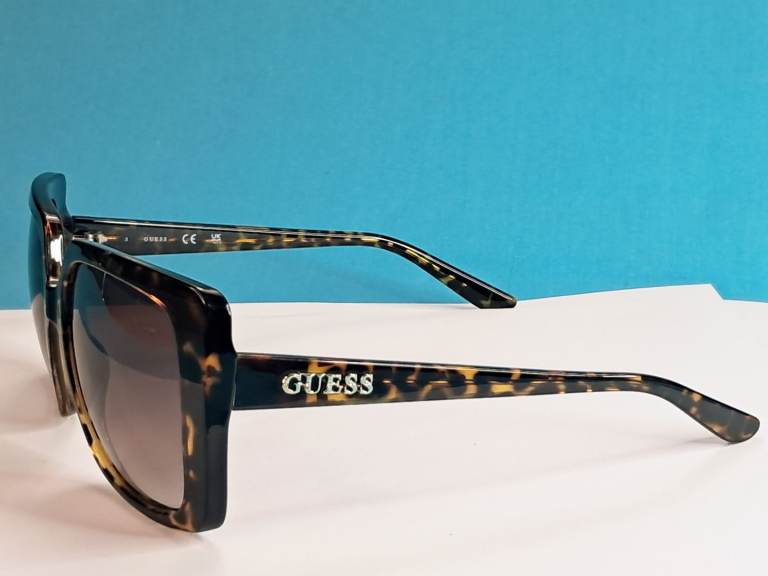 Women's Guess Sunglasses a  dark havana or tortoishell pattern and an oversized square. 