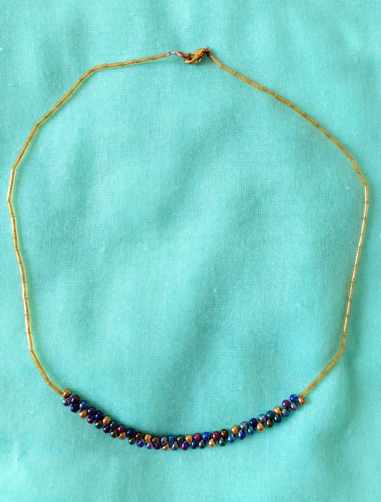 Purple and gold coloured bead necklace