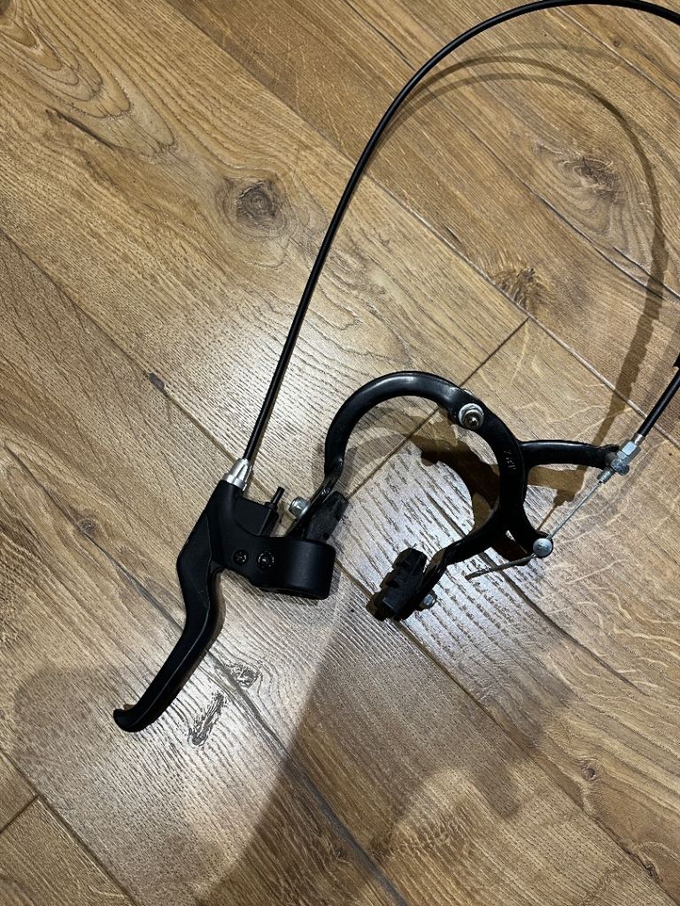 Generic bicycle caliper brake with lever Black bicycle caliper brake assembly with lever and cable