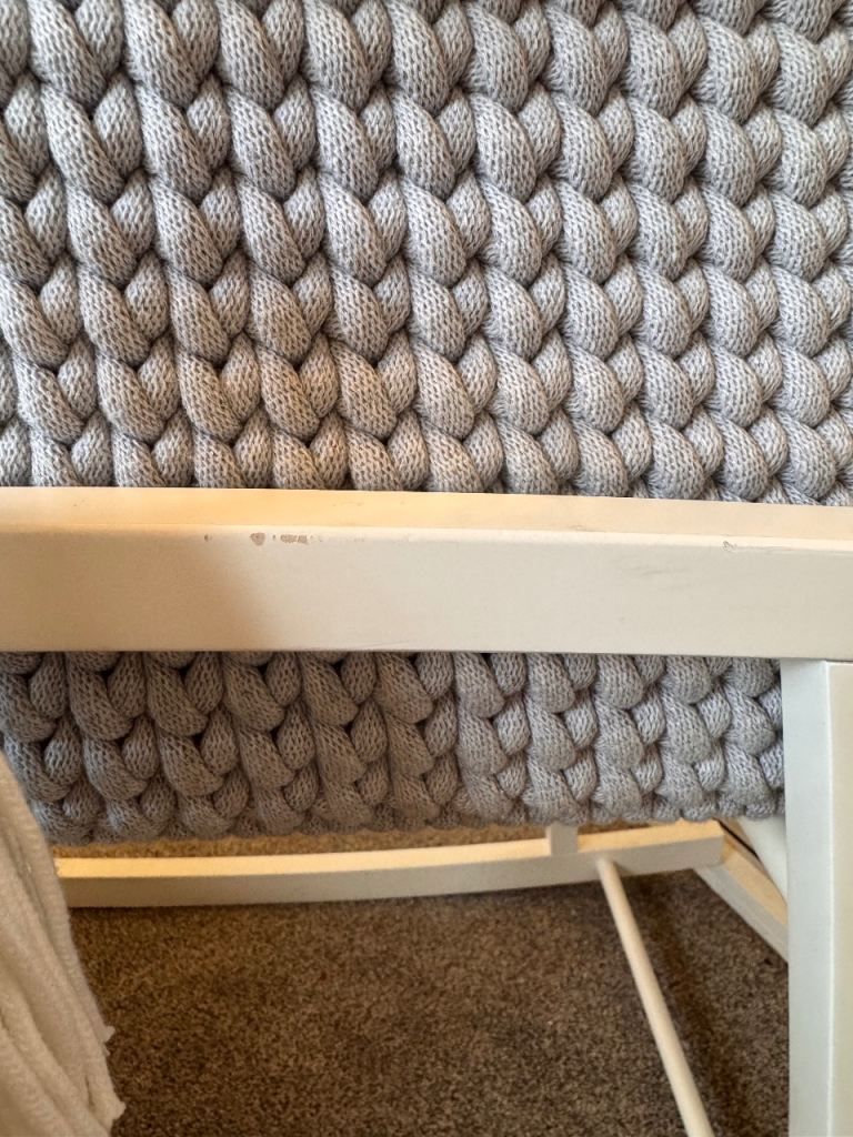 Light grey crochet crib with white wooden stand 