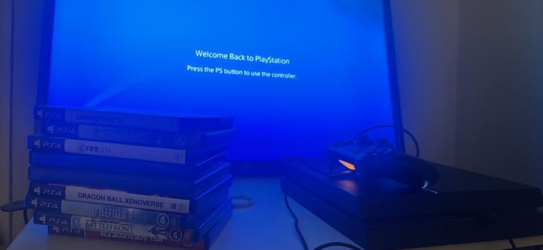 Sony PlayStation 4 Console with Controller and Games – Good Condition