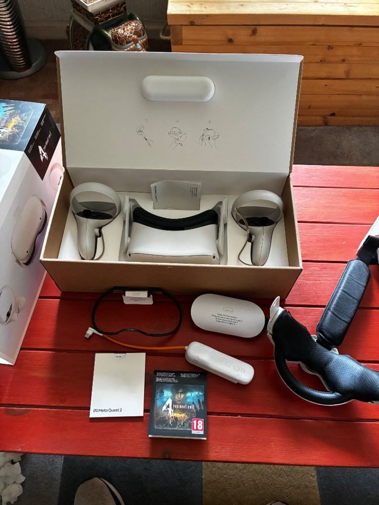 Meta Quest 2 in box with accessories and Resident Evil game 