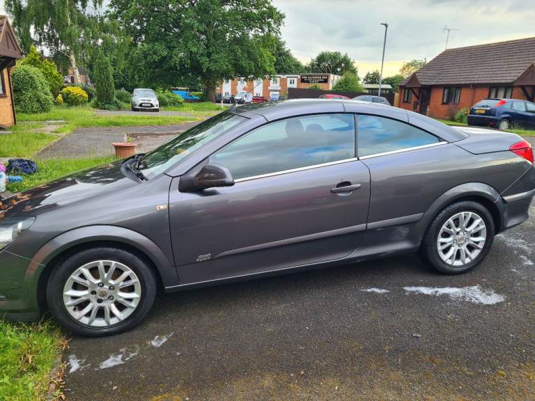 An automatic, silver twintop sport convertible with less than 57K on clock.