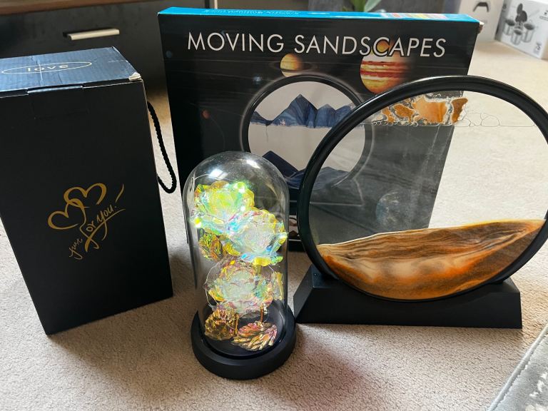 Three items: Rose flower in glass dome, a Moving sand art and a Christmas tree 