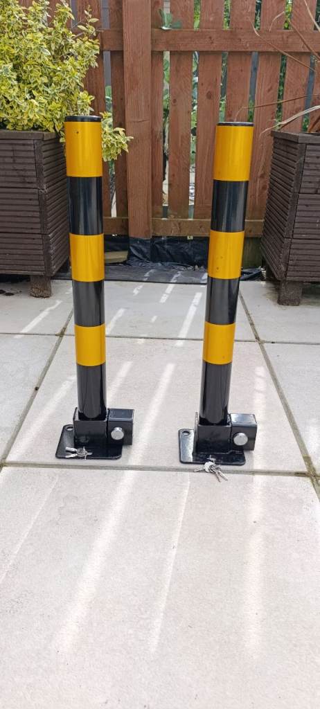Pair of Black and Yellow Fold Down Parking Posts