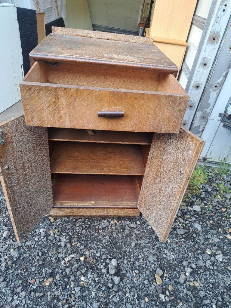 brown wood unit with drawer at the top and cupboard at the bottom