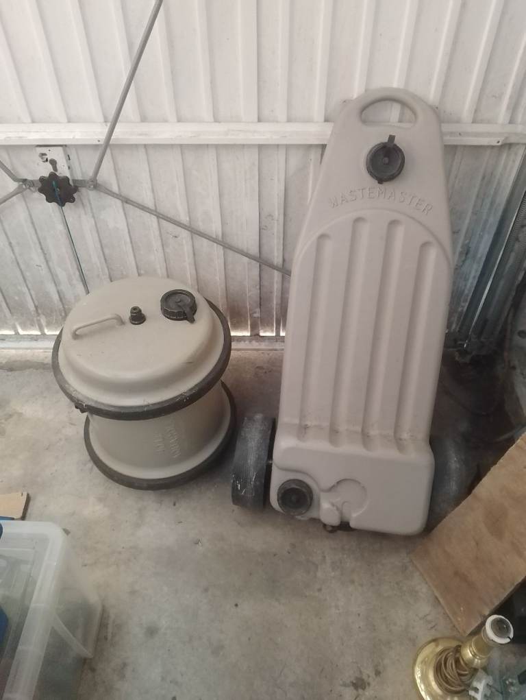 Caravan waste and water storage containers.
