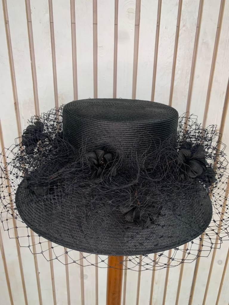 Graham Smith floral fascinator with a wide brim.