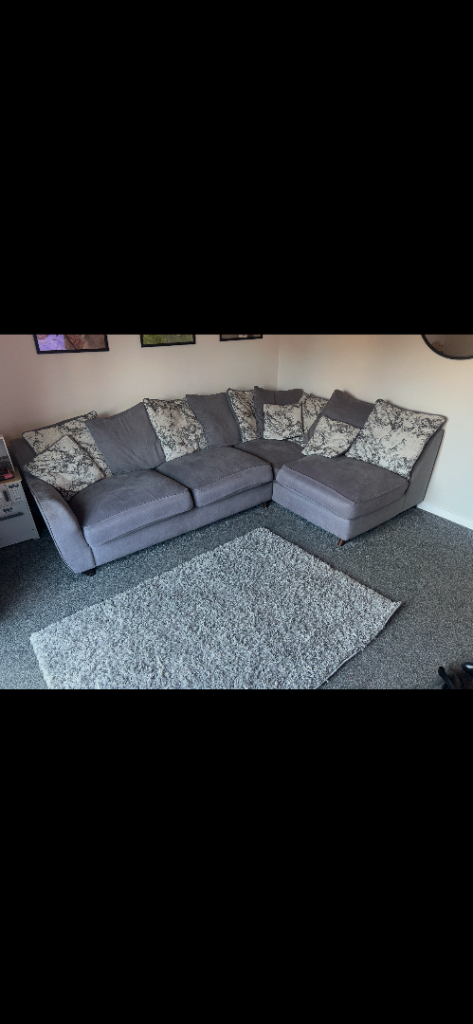 Grey Corner Sofa with Patterned Cushions – Good Condition