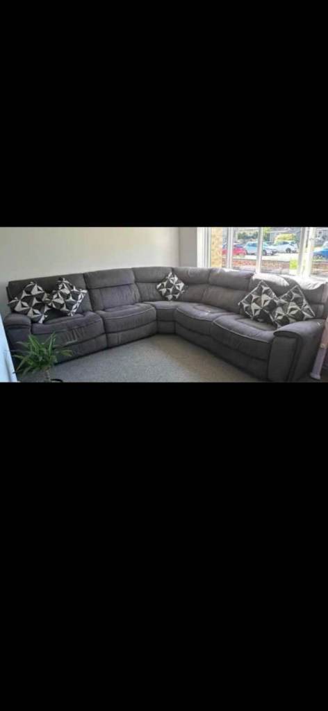 Grey corner sofa, with 3 electric recliners.  Delivery available 