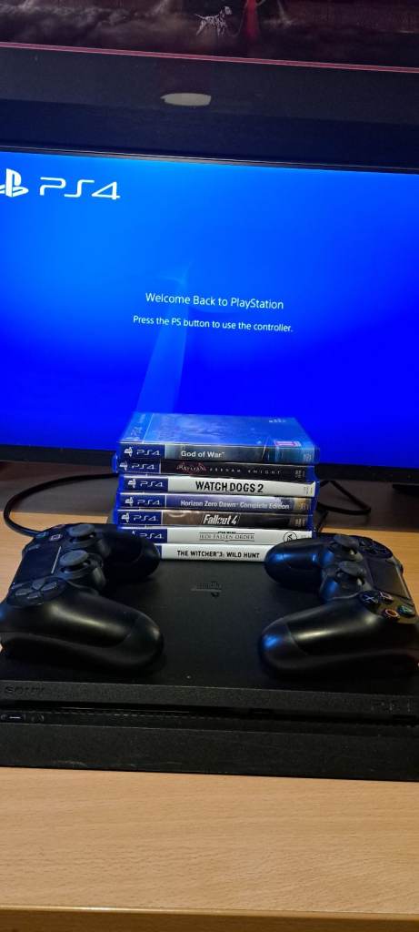 image for PS4 console with 2 controllers and 7 games including God of War and The Witcher