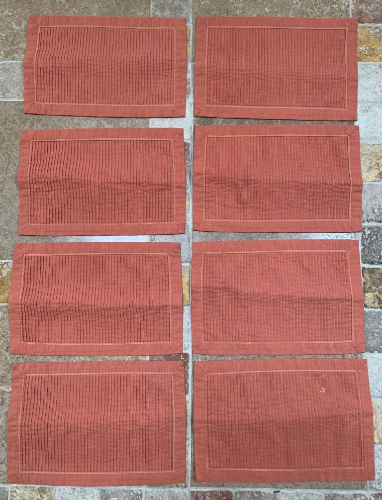 Eight coral placemats 