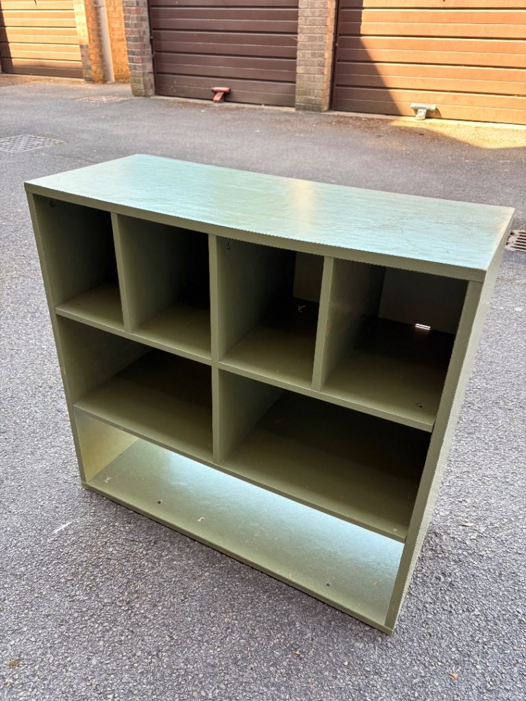 Sage green shelving unit.