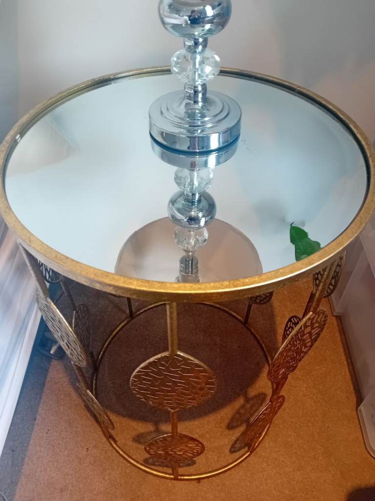 Side table with gold decorative edge and glass top
