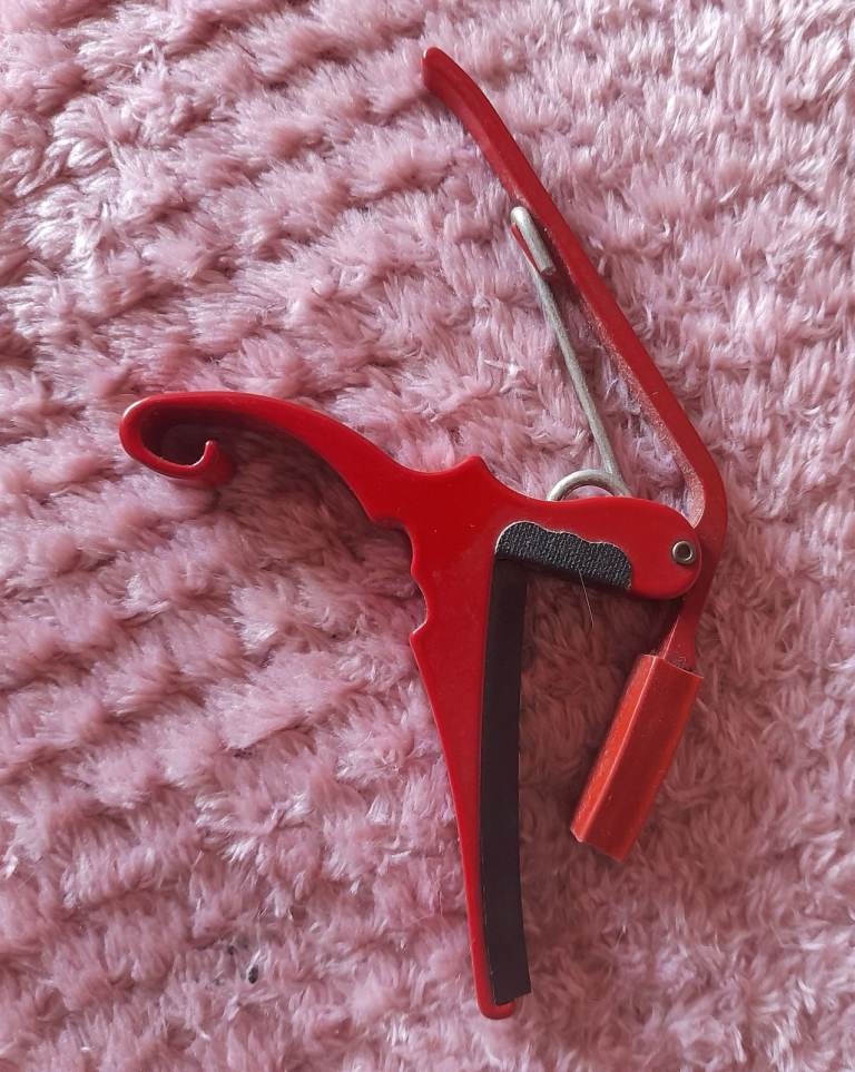 Red metal guitar capo