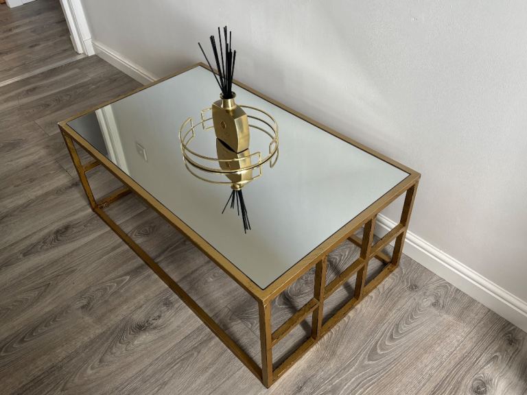 Mirrored coffee table with brushed gold effect metal base