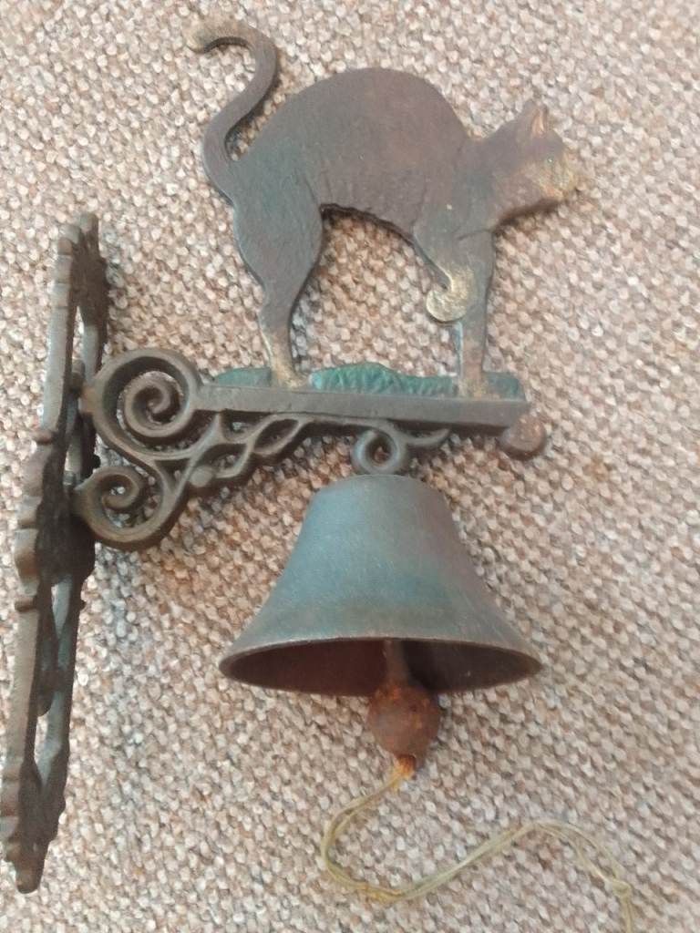 Very old Antique Bar bell featuring a Cat