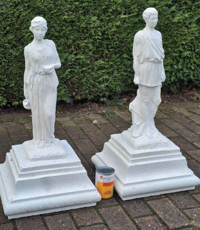 pair of painted stone figures on plinths / pier caps 