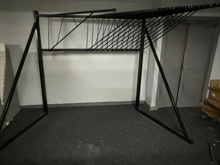Retail rug display stand with swinging arms 30 rugs up to 7 foot