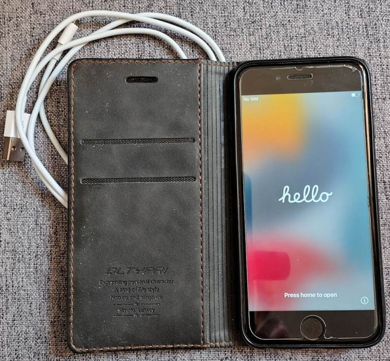 Apple iPhone 7 with Dark Leather Wallet Case and Charging Cable