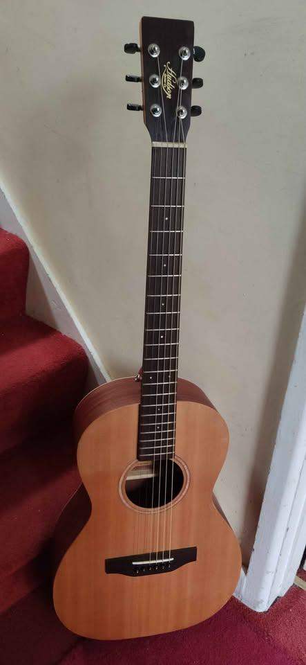 Left-Handed Hudson Electro Acoustic parlor size guitar. For ages 10 to adult.