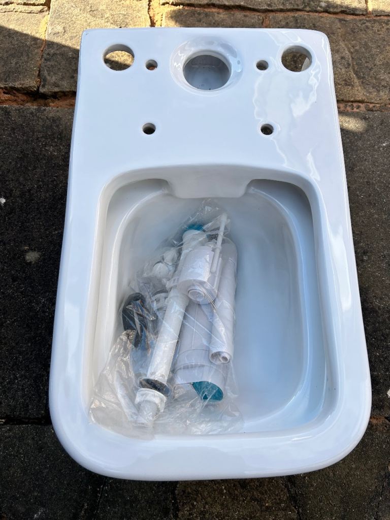 Toilet with lid, cistern lid, cistern fittings and bath end panel