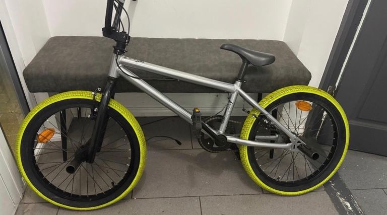 Silver and green Btwin Wipe 520 BMX bike