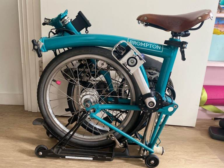 Blue Brompton folding bike with Swytch kit and Brooks saddle