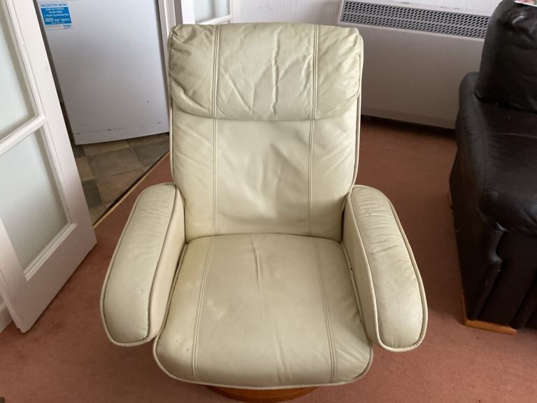 Comfortable cream leather recliner chair with a sturdy wooden base and a puff stool
This chair swive