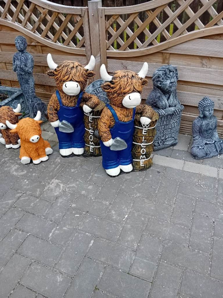 Concert garden statues off welcome highland cows 
