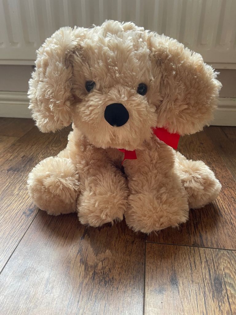 Children’s plush dog toy with ribbon, unplayed with.