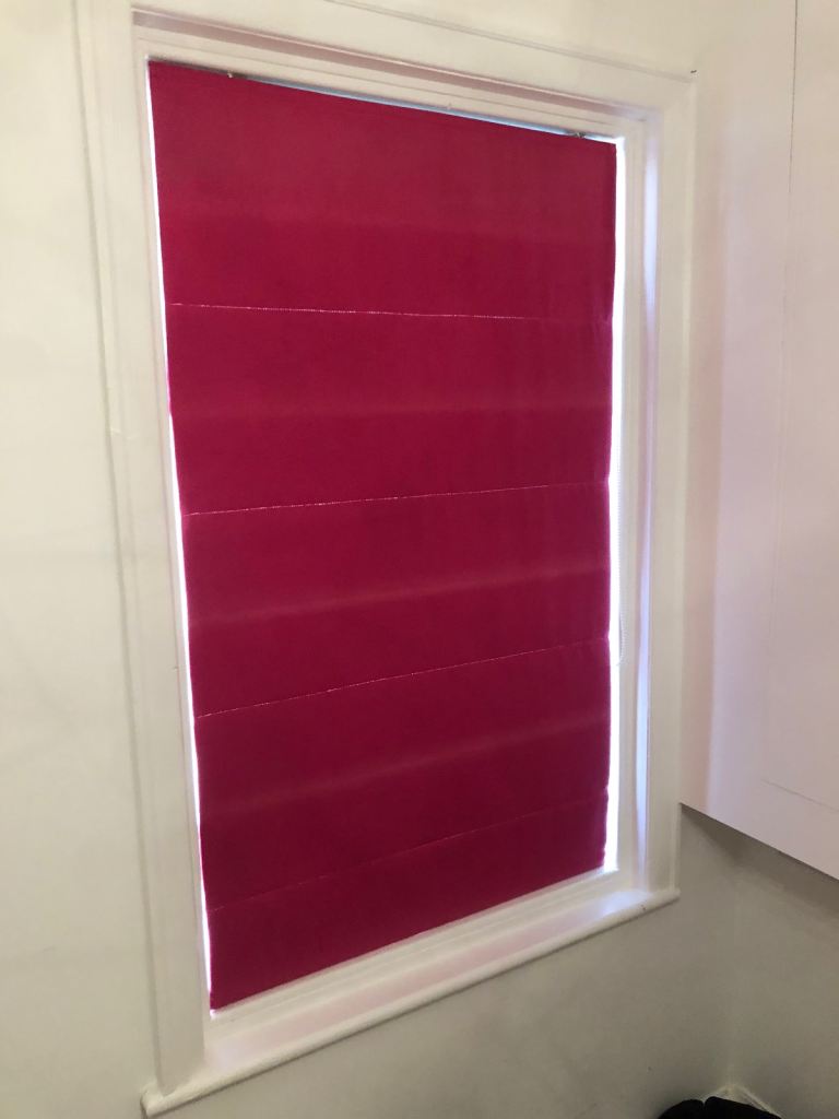 fuchsia-colored Roman blind